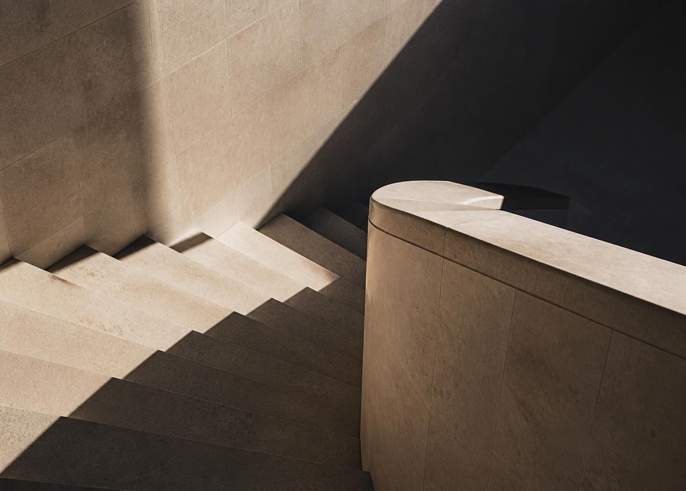 Sunlight crossing a limestone staircase and balustrade